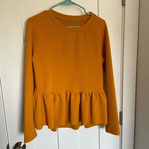 Textured peplum long sleeve top